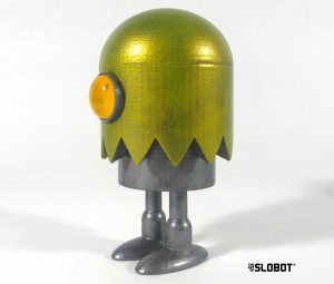 Slo-Ghost by Mike Slobot in metallic green. A robot hiding in a Ghost costume. Video Games and arcades